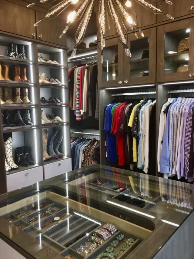 Organized Walk-in closet showing colour sorted shirts, cowboy boots, jewelry drawer - After Picture