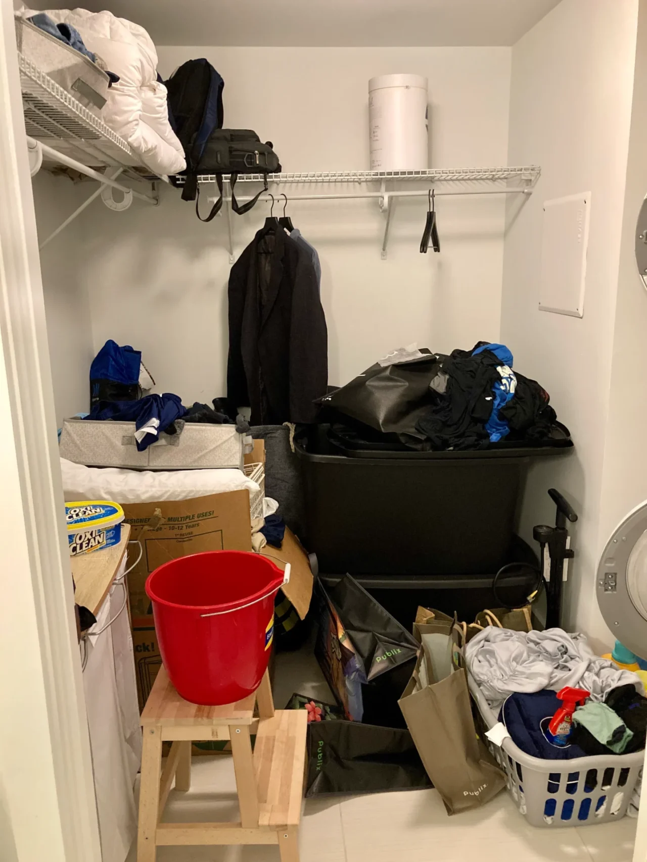 Before picture of a messy walk-in wardrobe